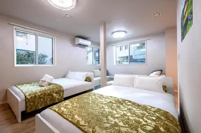 a room with two beds and a couch and windows at Ciel\u5357\u9ebb\u5e03 in Tokyo