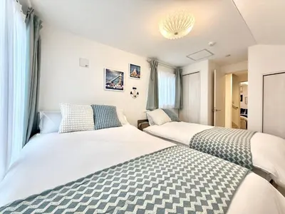 two beds in a small room with windows at Katsushika House\u67f4\u53c8 KS0340 in Tokyo