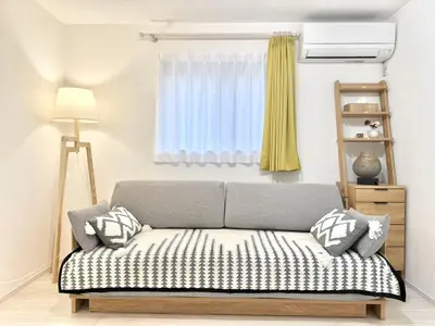 a living room with a couch and a window at Katsushika House\u67f4\u53c8 KS0340 in Tokyo