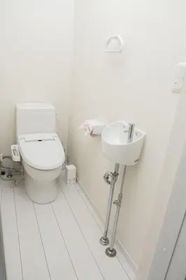 a white bathroom with a toilet and a sink at Ikebukuro House-TS0378 in Tokyo