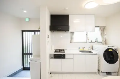 a white kitchen with a sink and a dishwasher at Ikebukuro House-TS0378 in Tokyo