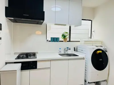 a white kitchen with a sink and a stove at Ikebukuro House-TS0378 in Tokyo