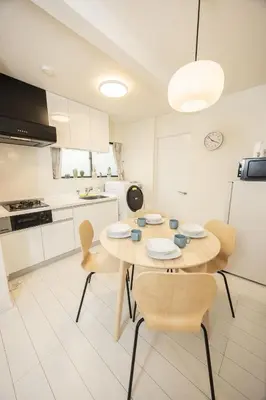 a kitchen with a table and chairs and a refrigerator at Ikebukuro House-TS0378 in Tokyo