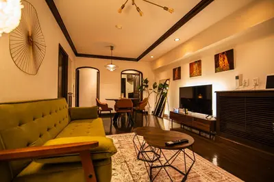 a living room with a couch and a table at \u30b5\u30f3\u30e2\u30fc\u30eb\u30af\u30ec\u30b9\u30c8306 in Tokyo