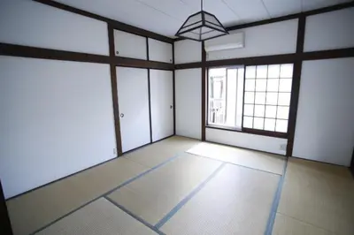 an empty room with a large room with windows at Yanesen Traditional Nagaya house in Tokyo