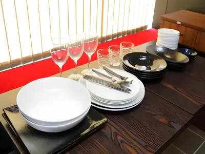 a table with white plates and wine glasses on it at Chaan Ueno Hotel - Vacation STAY 01162v in Tokyo