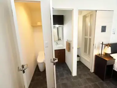 a bathroom with a toilet and a sink and a mirror at Chaan Ueno Hotel - Vacation STAY 01162v in Tokyo