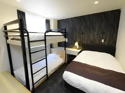 a bedroom with two bunk beds and a bed at Chaan Ueno Hotel - Vacation STAY 01152v in Tokyo