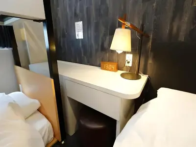 a small bathroom with a desk and a bed at Chaan Ueno Hotel - Vacation STAY 01152v in Tokyo