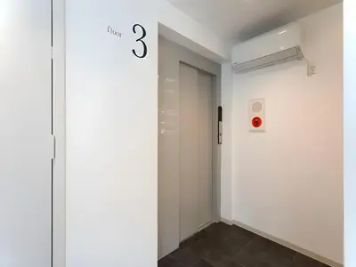 a hallway with a door with the number three on the wall at Chaan Ueno Hotel - Vacation STAY 01152v in Tokyo