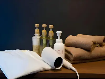 a group of bottles on a table with a hair dryer at Chaan Ueno Hotel - Vacation STAY 01159v in Tokyo