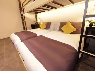 a bedroom with two bunk beds with yellow pillows at Chaan Ueno Hotel - Vacation STAY 01157v in Tokyo