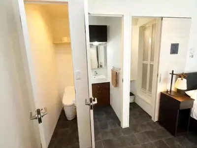 a room with a bathroom with a toilet and a mirror at Chaan Ueno Hotel - Vacation STAY 01157v in Tokyo