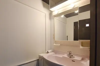 a white bathroom with a sink and a mirror at Okada Building - Vacation STAY 18449 in Tokyo