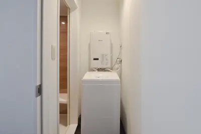 a bathroom with a white dryer sitting on top of a toilet at Okada Building - Vacation STAY 18449 in Tokyo