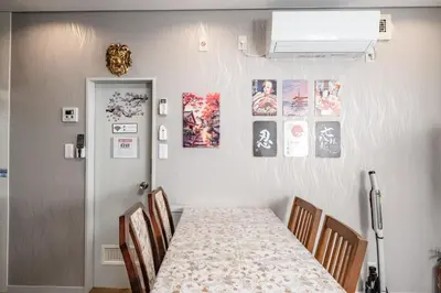 a dining room with a table and some pictures on the wall at Qiao318,Mejiro - Vacation STAY 20385v in Tokyo