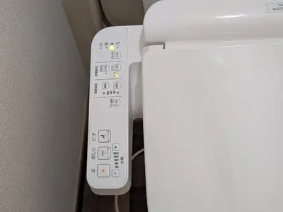 a white remote control next to a white refrigerator at \u6771\u4eac\u306e\u4e2d\u5fc3\u5730 Okachimachi Staypia in Tokyo