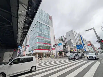 a busy city street with cars on a crosswalk at \u6771\u4eac\u306e\u4e2d\u5fc3\u5730 Okachimachi Staypia in Tokyo