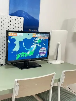 a computer monitor sitting on top of a desk at \u7d50\u5948\u5e0c Yunakis House in Tokyo