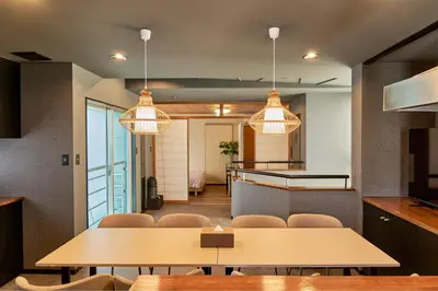 a dining room with tables and chairs and lights at ACOE Higashi-Shinjuku Gourmet Area in Tokyo