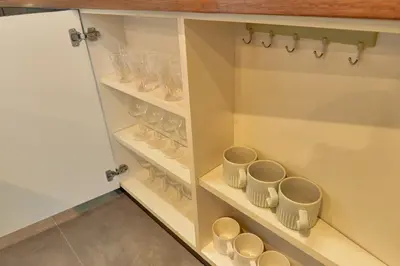 a cupboard full of cups and saucers at ACOE Higashi-Shinjuku Gourmet Area in Tokyo