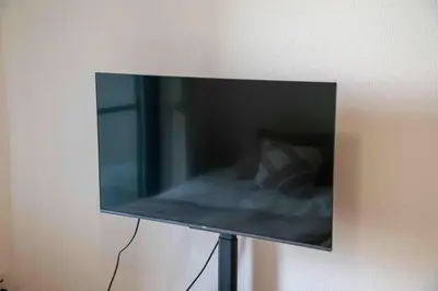 a flat screen tv hanging on a wall at FIKA Higashi Shinjuku in Tokyo