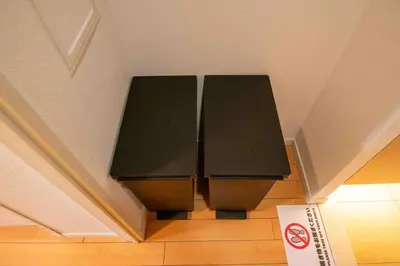 a black bench in the corner of a room at FIKA Higashi Shinjuku in Tokyo