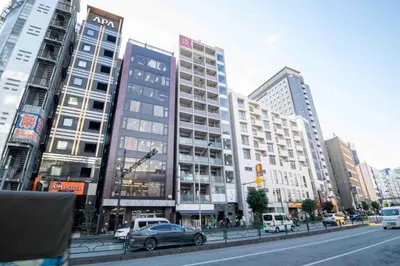 a busy city street with tall buildings and cars at FIKA Higashi Shinjuku in Tokyo