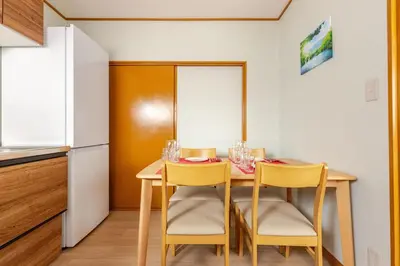 a small kitchen with a table and two chairs at Fukurou House in Tokyo