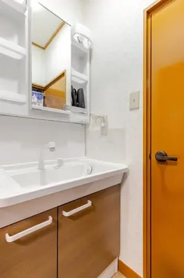 a bathroom with a sink and a mirror at Fukurou House in Tokyo