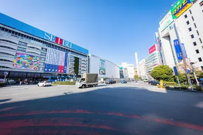 a street in a city with a truck on the road at Fukurou House in Tokyo