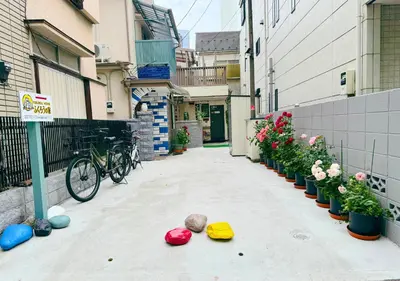 an alley with flowers and balls on the ground at Fukurou House in Tokyo