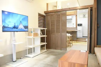 a living room with a flat screen tv on a wall at Asakusa Sky House in Tokyo