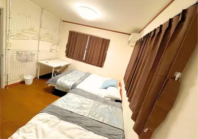 a hospital room with two beds and a window at Asakusa Sky House in Tokyo