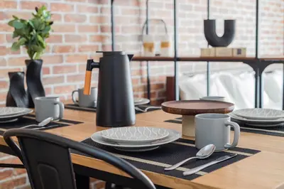 a wooden table with plates and utensils on it at Stay Ikebukuro in Tokyo