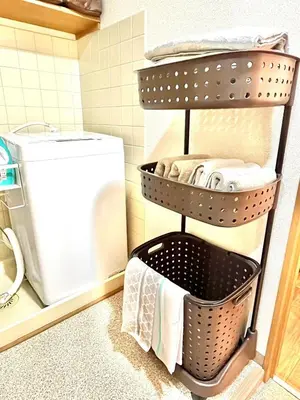 a drying rack in a bathroom with a washing machine at Stay Ikebukuro in Tokyo
