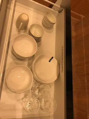 a display case filled with white plates and bowls at \u6728\u6751\u5c4b-\u6c60\u888b Kimuraya-Ikebukuro in Tokyo