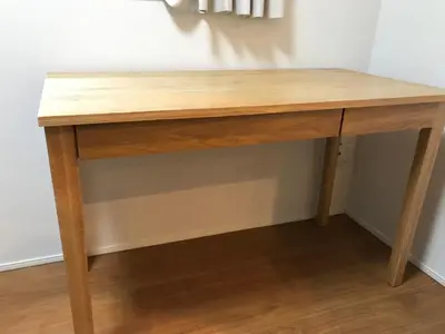 a wooden desk in a corner of a room at \u6728\u6751\u5c4b-\u6c60\u888b Kimuraya-Ikebukuro in Tokyo