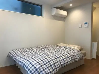 a bedroom with a bed and a window in it at \u6728\u6751\u5c4b-\u6c60\u888b Kimuraya-Ikebukuro in Tokyo