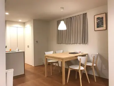 a kitchen and dining room with a table and chairs at \u6728\u6751\u5c4b-\u6c60\u888b Kimuraya-Ikebukuro in Tokyo