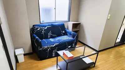 a blue leather chair in a room with a table at Mamada Building - Vacation STAY 18481 in Tokyo