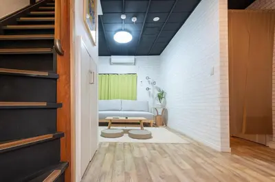 a living room with a couch and a table at \u697d\u9038\u30b0\u30eb\u30fc\u30d7 \u56db\u30c4\u6728 102t in Tokyo