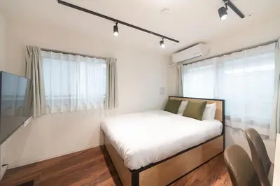 a bedroom with a bed and a large window at \u30b0\u30ec\u30a4\u30b9\u30a2\u30fc\u30b9\u30ec\u30b8\u30c7\u30f3\u30b9\u5317\u5343\u4f4f in Tokyo