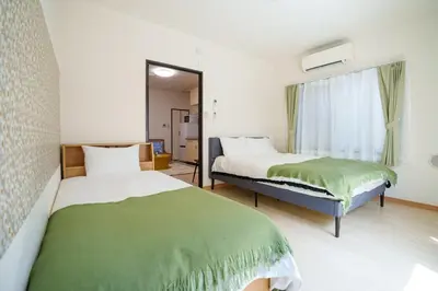 a bedroom with two beds and a window at Asakusa\u5f92\u6b692\u5206 MAX5\u540d Asakusa\u99c5\u304b\u3089\u5f92\u6b696\u5206 in Tokyo