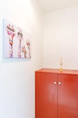 a red cabinet in a room with a painting on the wall at Asakusa\u5f92\u6b692\u5206 MAX5\u540d Asakusa\u99c5\u304b\u3089\u5f92\u6b696\u5206 in Tokyo