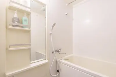 a white bathroom with a shower and a sink at Asakusa\u5f92\u6b692\u5206 MAX5\u540d Asakusa\u99c5\u304b\u3089\u5f92\u6b696\u5206 in Tokyo