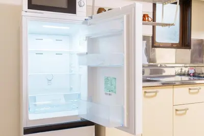 an empty refrigerator with its door open in a kitchen at Asakusa\u5f92\u6b692\u5206 MAX5\u540d Asakusa\u99c5\u304b\u3089\u5f92\u6b696\u5206 in Tokyo