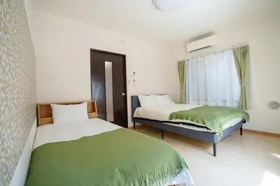 a bedroom with two beds and a window at Asakusa\u5f92\u6b692\u5206 MAX5\u540d Asakusa\u99c5\u304b\u3089\u5f92\u6b696\u5206 in Tokyo