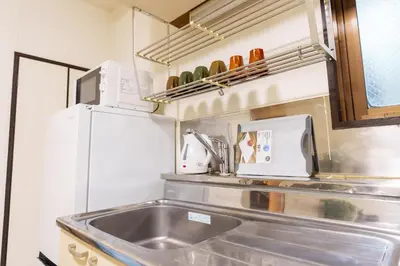 a kitchen with a sink and a microwave at Asakusa\u5f92\u6b692\u5206 MAX5\u540d Asakusa\u99c5\u304b\u3089\u5f92\u6b696\u5206 in Tokyo