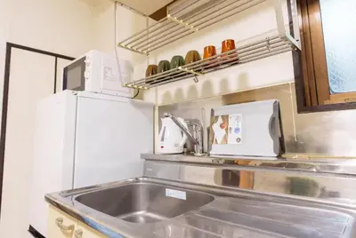 a kitchen with a sink and a microwave at Asakusa\u5f92\u6b692\u5206 MAX5\u540d Asakusa\u99c5\u304b\u3089\u5f92\u6b696\u5206 in Tokyo
